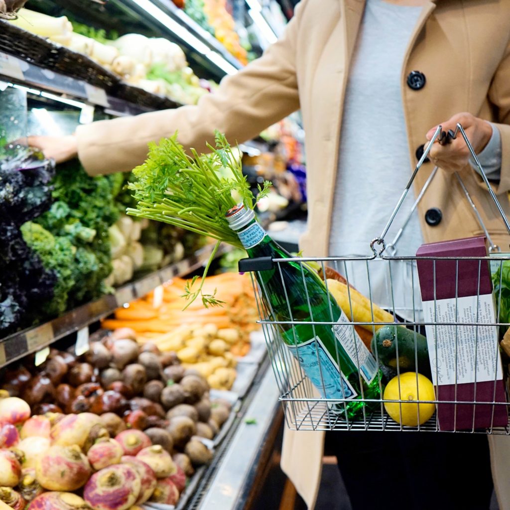 aide à domicile faisant les courses dans les rayons d'un supermarché