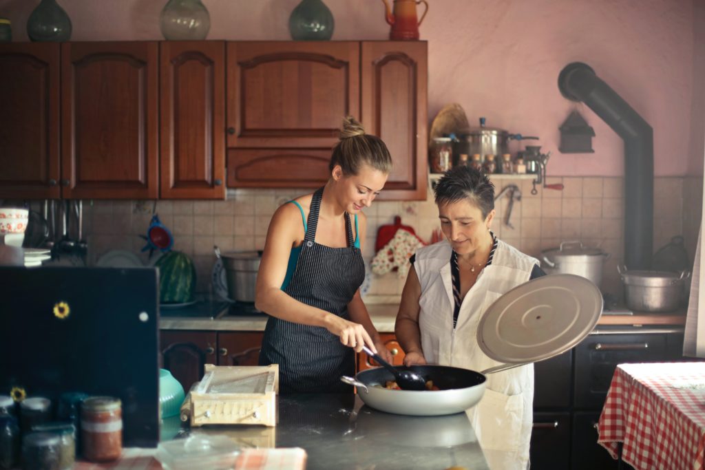 aide à domicile préparant e repas avec une dame âgée